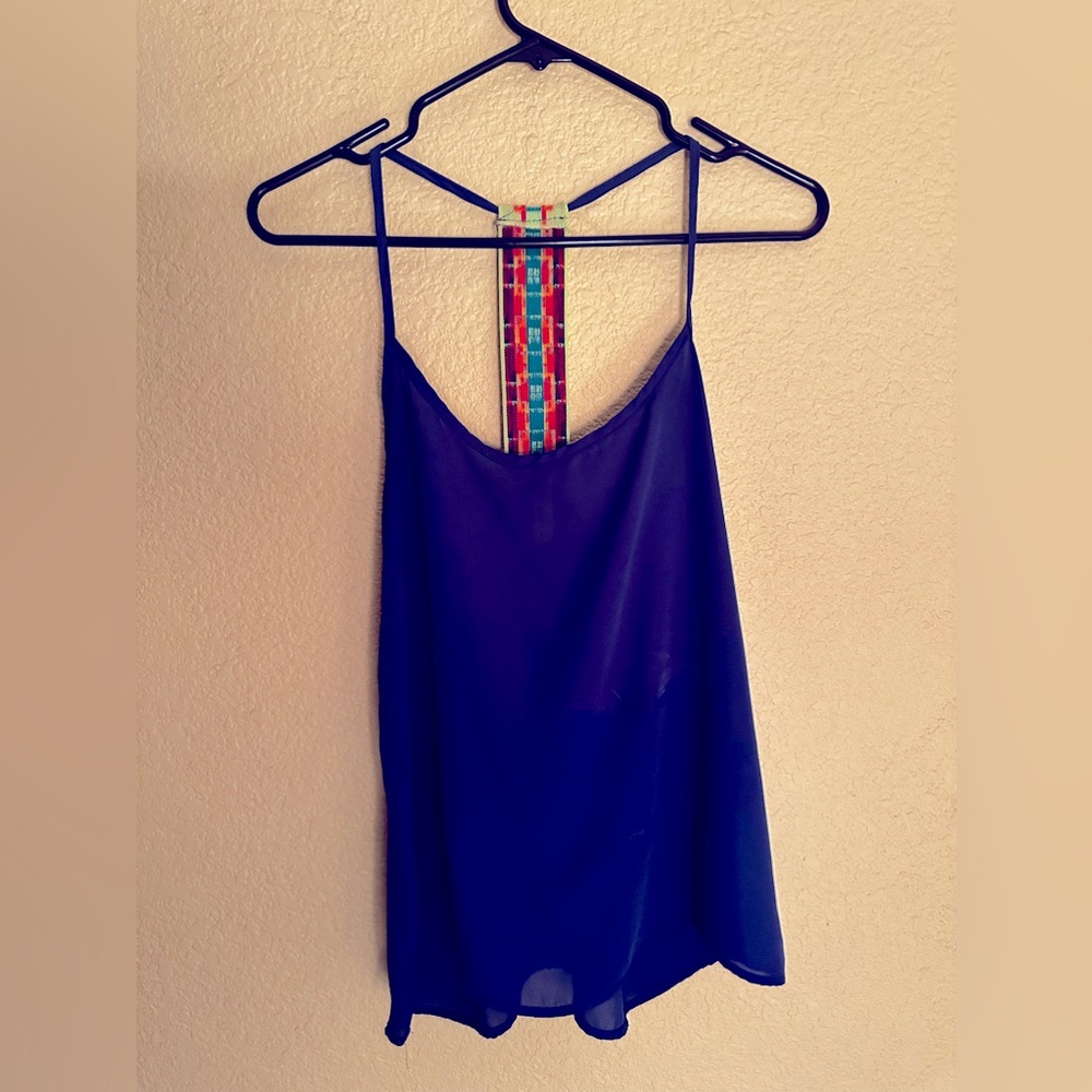 Flowey tank top with spaghetti straps. Back side has a colorful elastic strap.